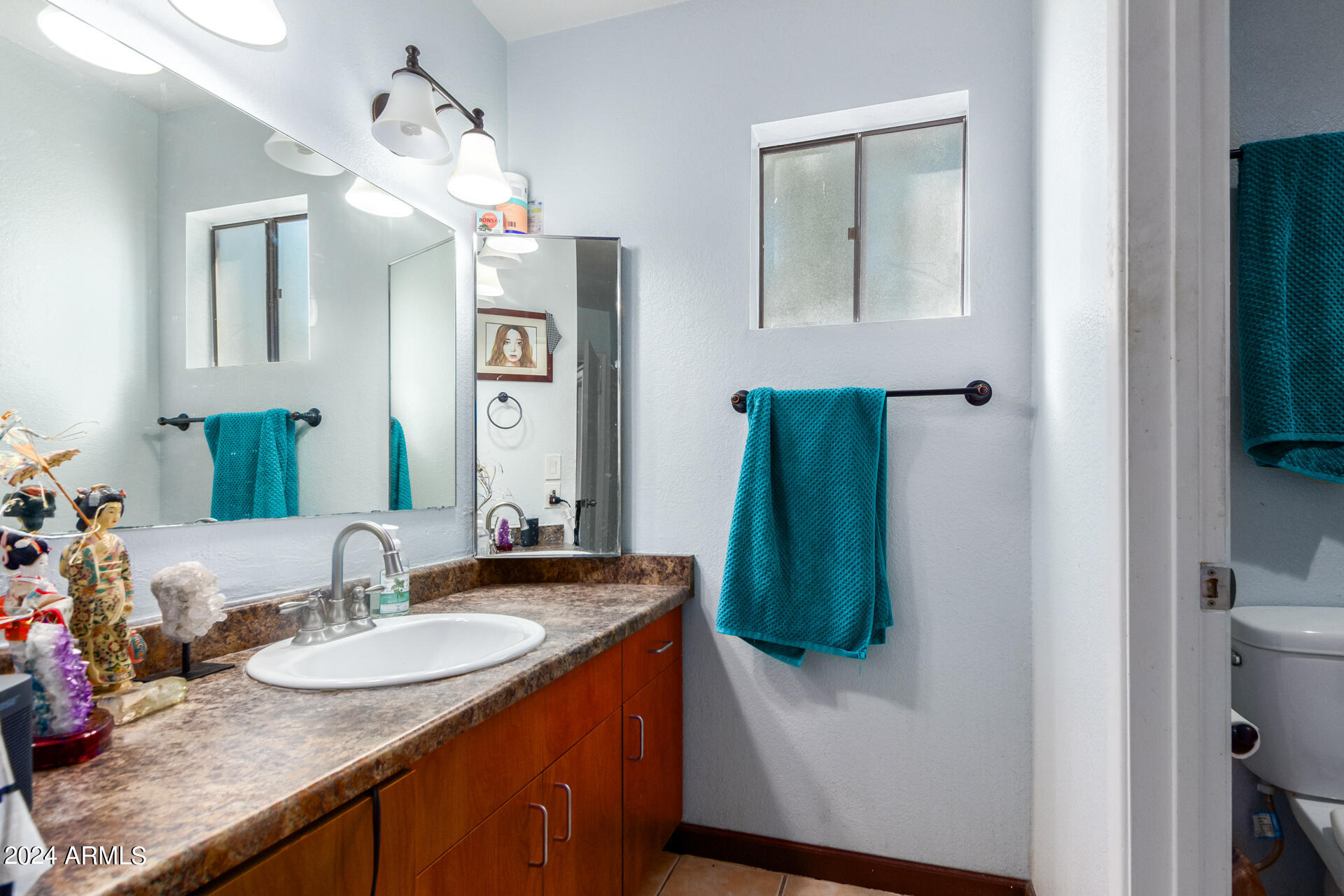 3422 North 12th Place Phoenix, AZ 85014 - Photo 36 of 49 a bathroom with sink and mirror