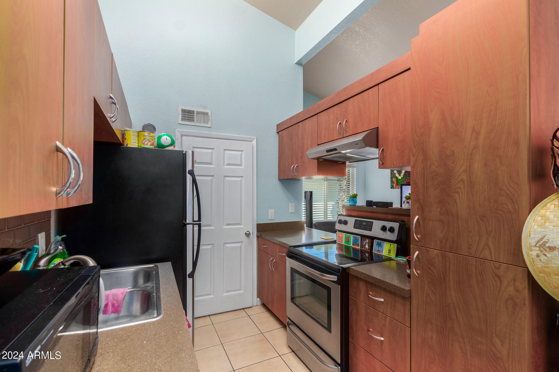 3422 North 12th Place Phoenix, AZ 85014 - Photo 43 of 49 a kitchen with stainless steel appliances granite countertop a refrigerator and a stove