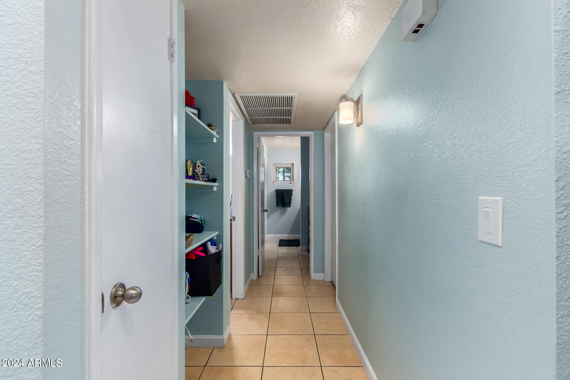 3422 North 12th Place Phoenix, AZ 85014 - Photo 44 of 49 a view of a hallway with wooden shelves