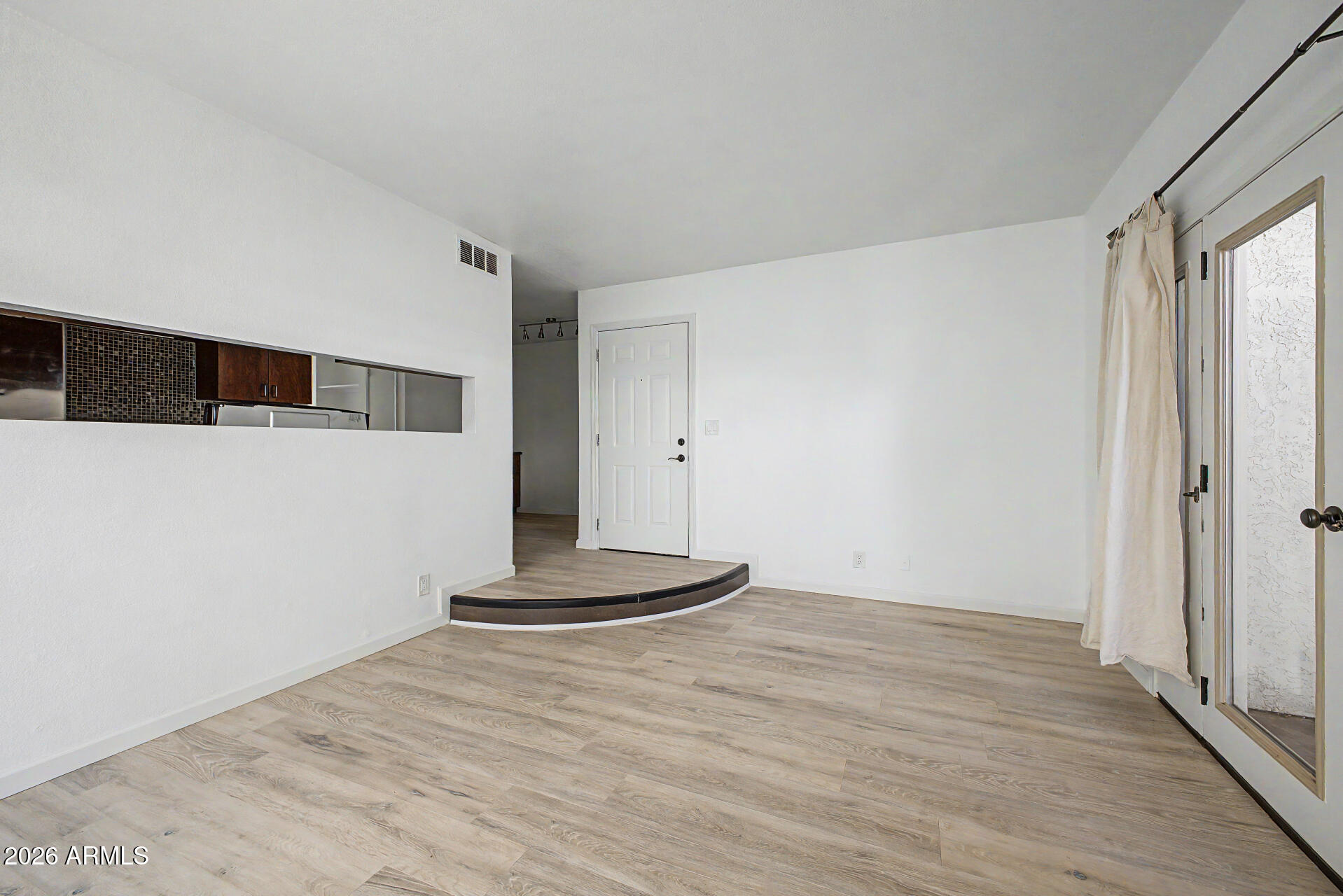 3422 North 12th Place Phoenix, AZ 85014 - Photo 5 of 49 a view of an empty room with wooden floor