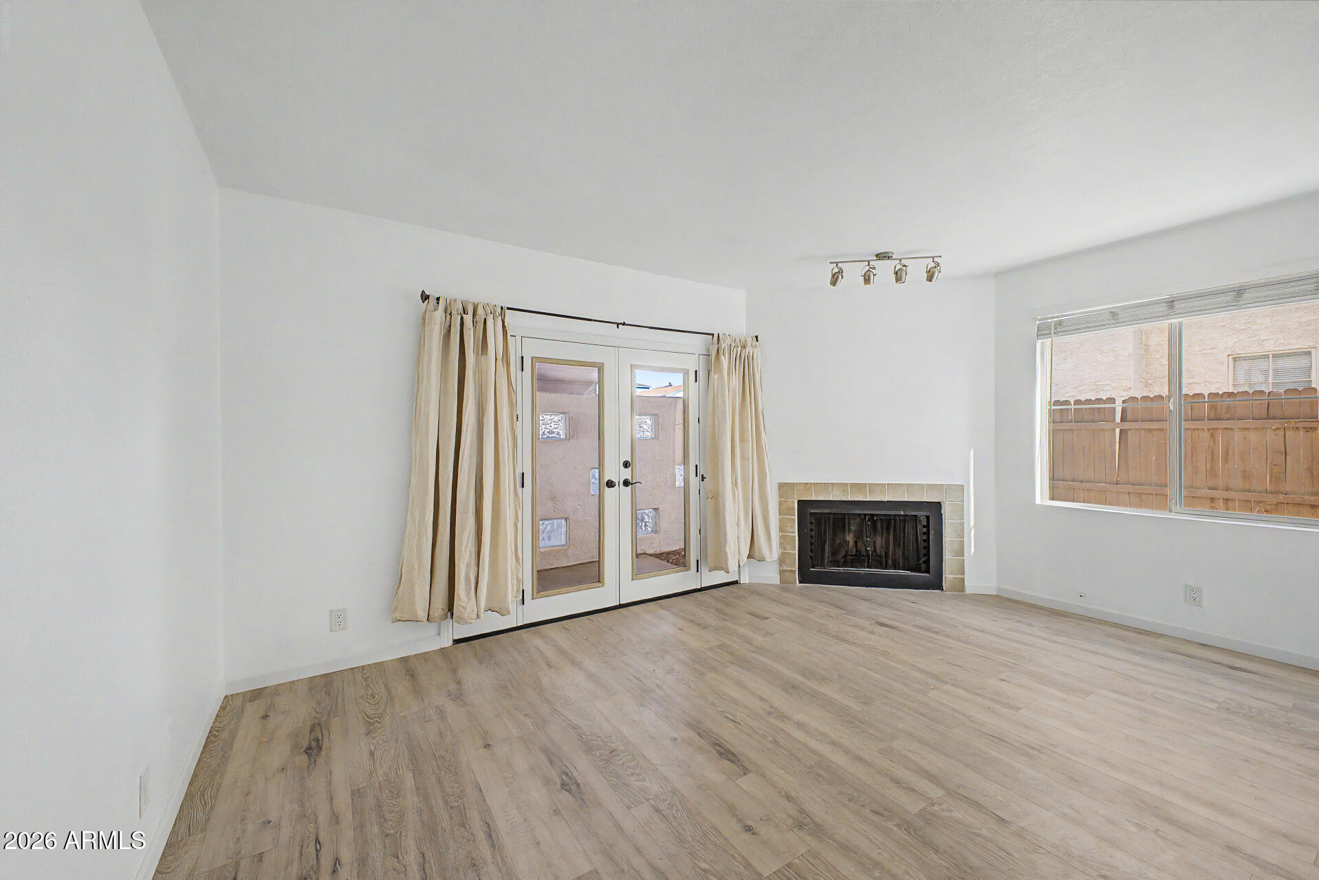 3422 North 12th Place Phoenix, AZ 85014 - Photo 6 of 49 an empty room with windows fire place and windows