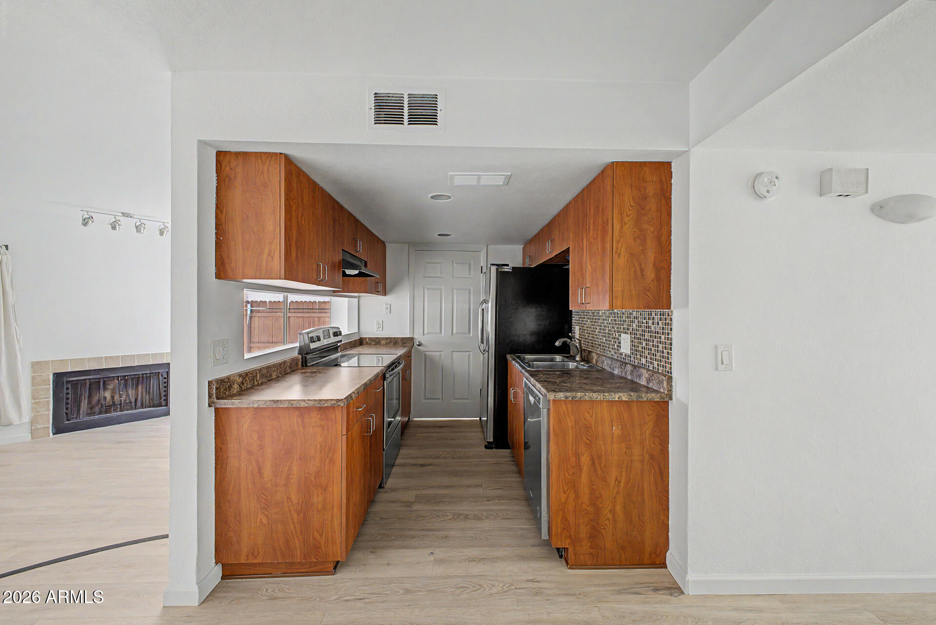 3422 North 12th Place Phoenix, AZ 85014 - Photo 7 of 49 a kitchen with a stove a sink and a refrigerator