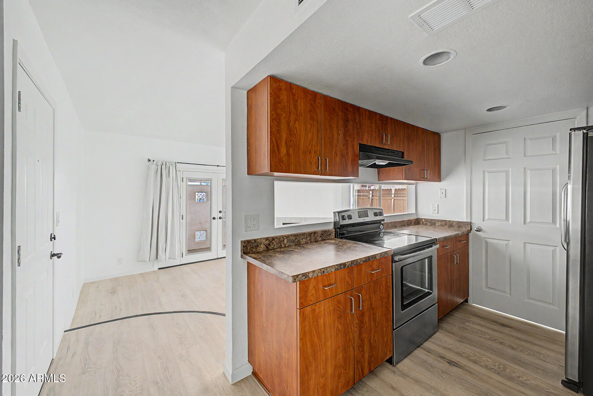 3422 North 12th Place Phoenix, AZ 85014 - Photo 8 of 49 a kitchen with stainless steel appliances granite countertop a stove a sink and a refrigerator