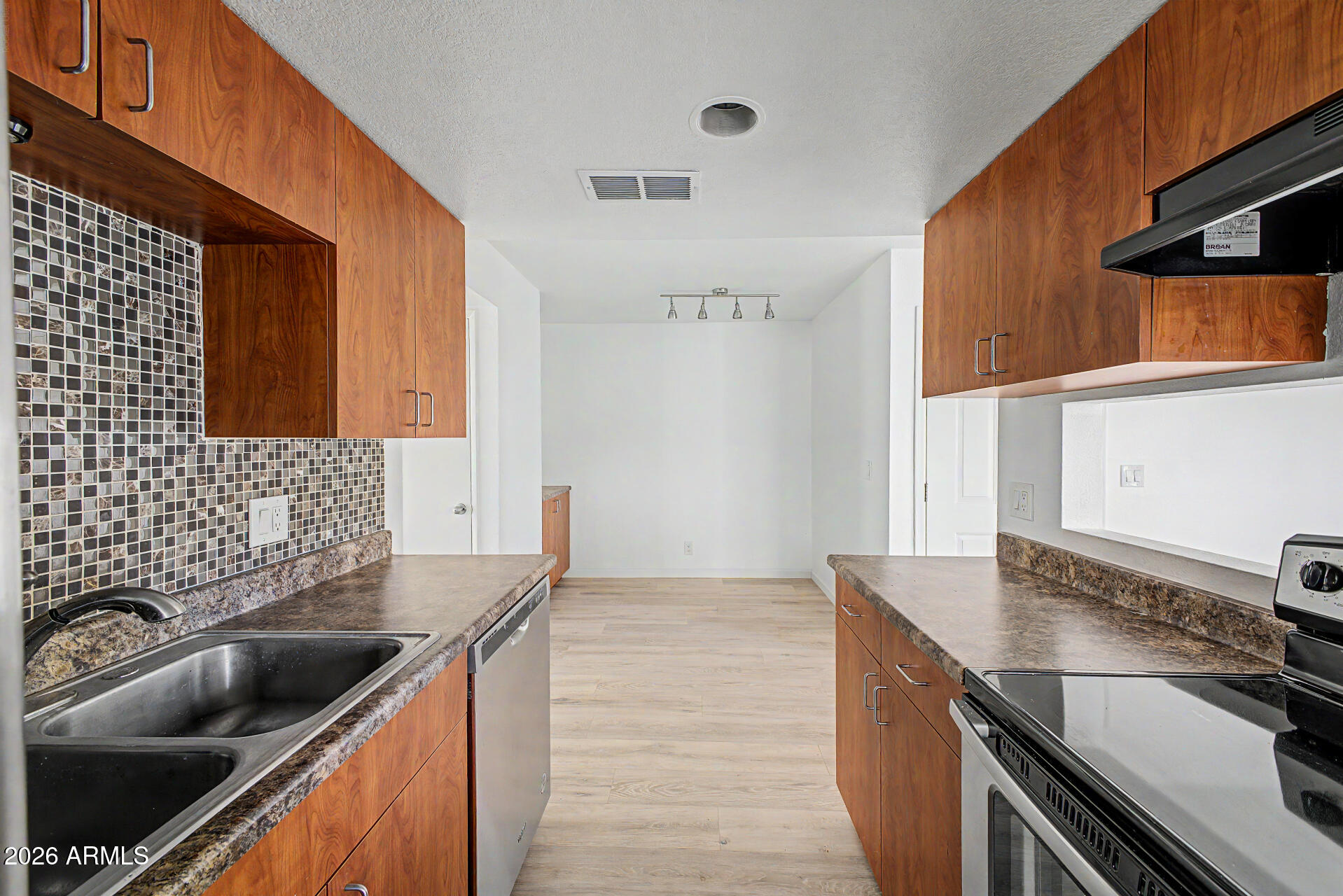3422 North 12th Place Phoenix, AZ 85014 - Photo 9 of 49 a kitchen with stainless steel appliances granite countertop a sink and a stove