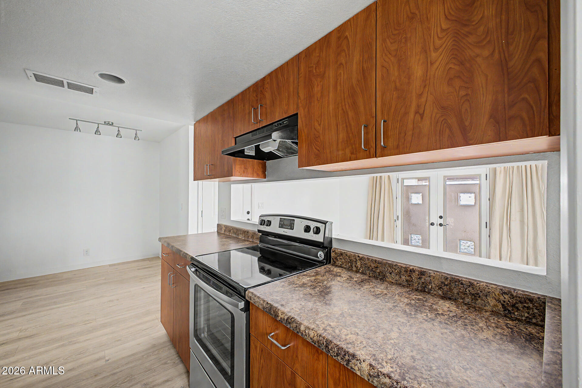 3422 North 12th Place Phoenix, AZ 85014 - Photo 10 of 49 a kitchen with a stove and a microwave
