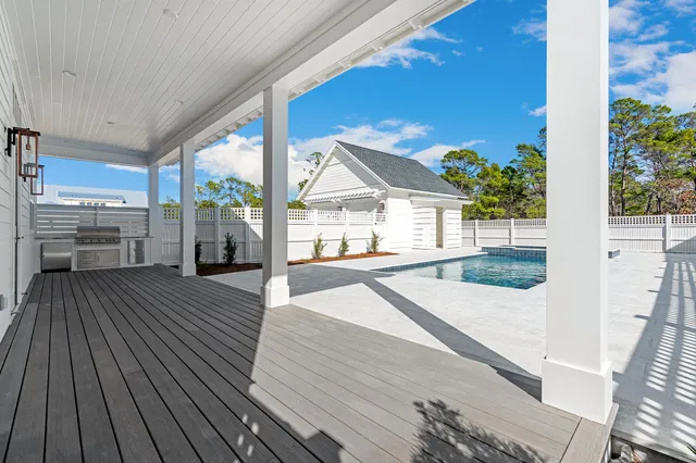 an aerial view of residential houses with outdoor space and swimming pool