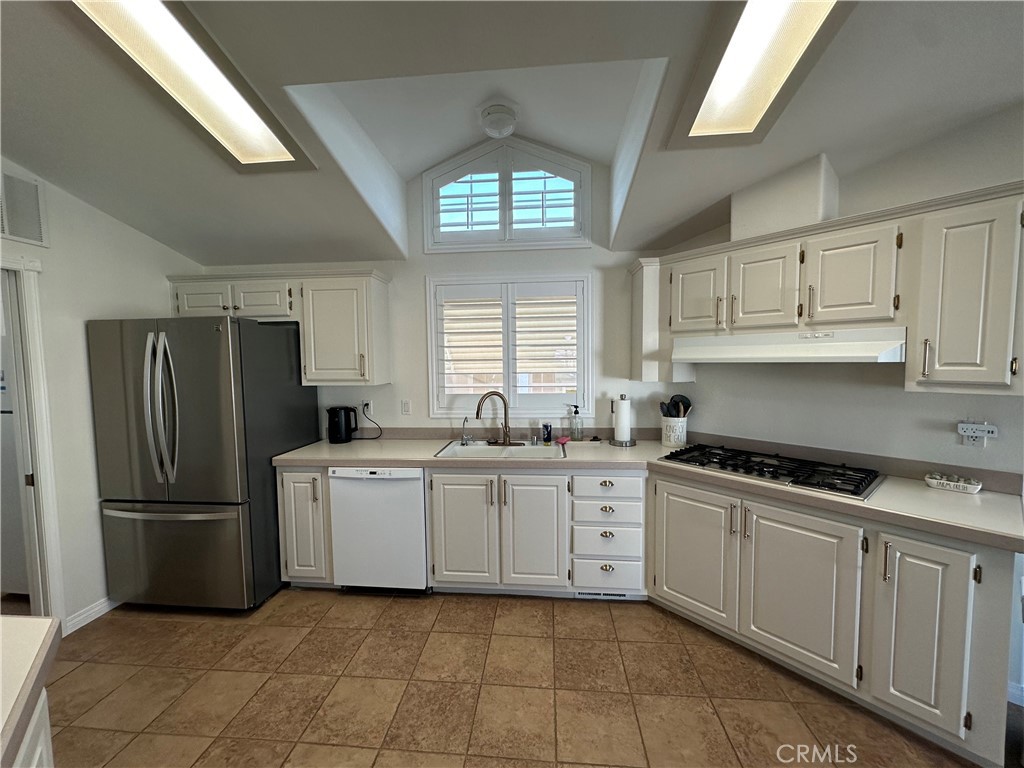 50761 Parker Dam Road, Unit 71 Big River, CA 92242 - Photo 11 of 23 a kitchen with a refrigerator a stove a sink and cabinets