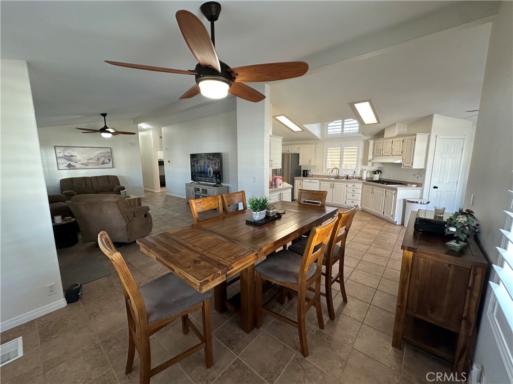 50761 Parker Dam Road, Unit 71 Big River, CA 92242 - Photo 14 of 23 a dining room with stainless steel appliances kitchen island granite countertop furniture and a view of kitchen