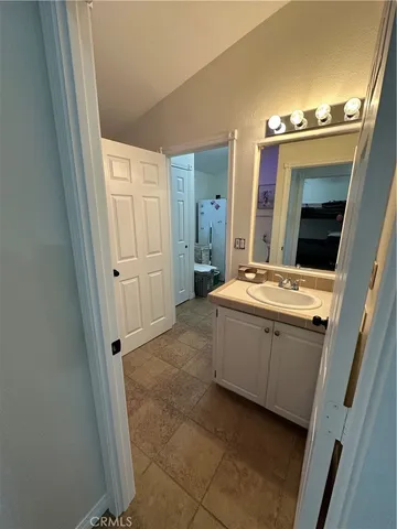 a bathroom with a sink vanity and mirror