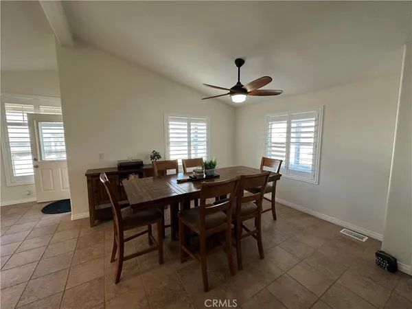 a view of a dining room with furniture and window