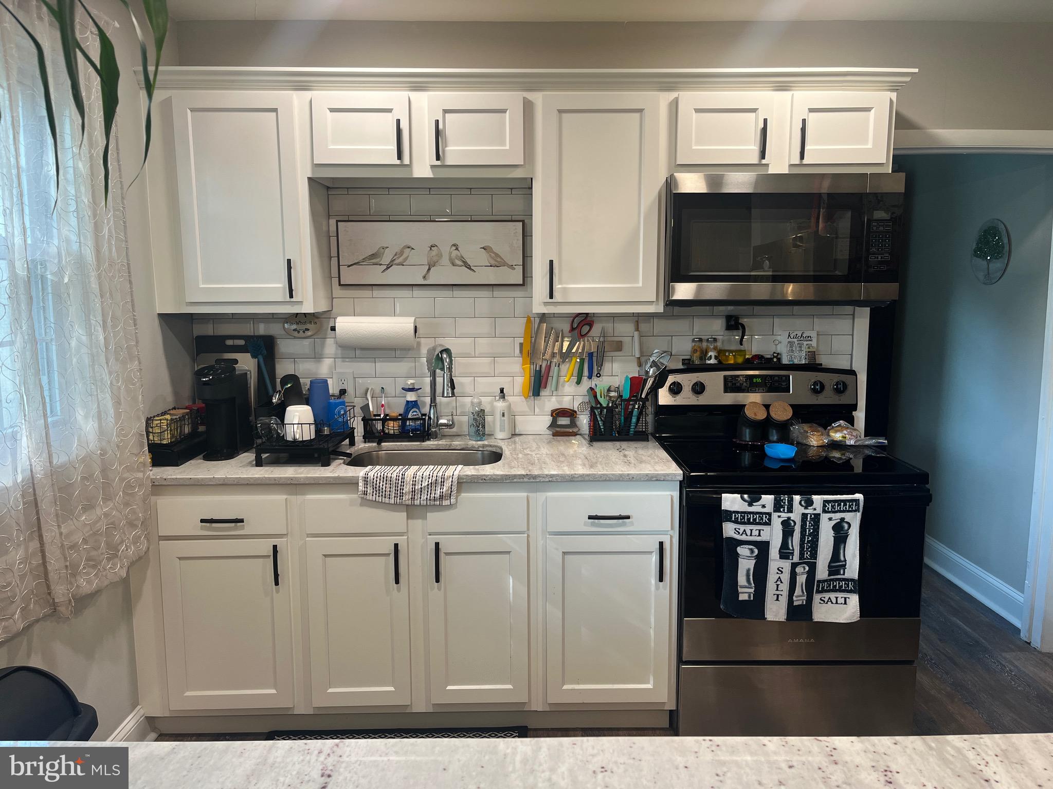 499 Prospect Road Warminster, PA 18974 - Photo 35 of 48 a kitchen with stainless steel appliances granite countertop a sink stove and microwave