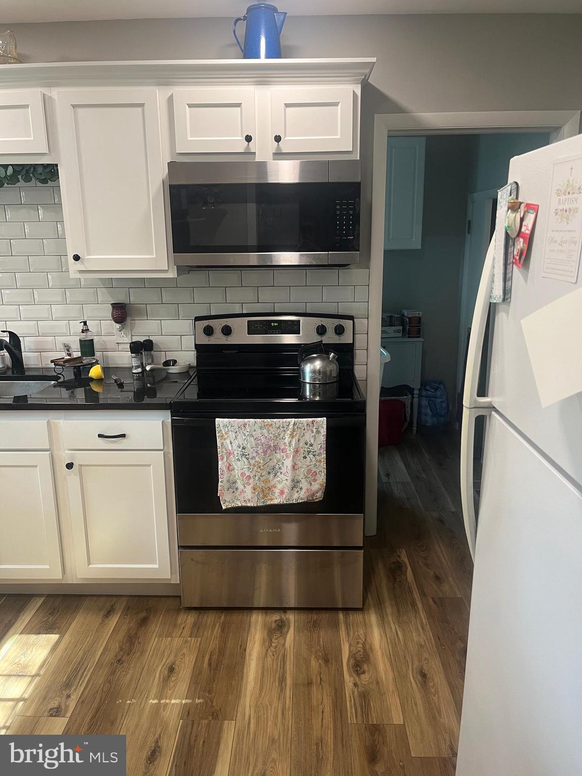 499 Prospect Road Warminster, PA 18974 - Photo 10 of 48 a kitchen with granite countertop a stove a microwave a sink and cabinets