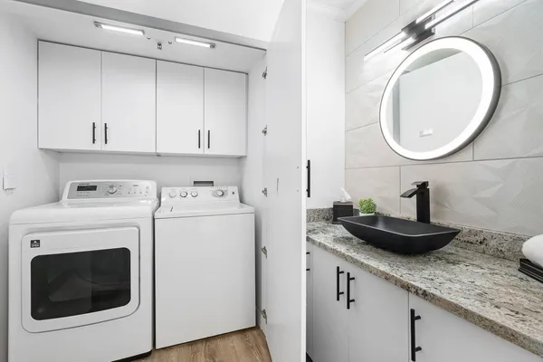 a view of a sink and washer and dryer