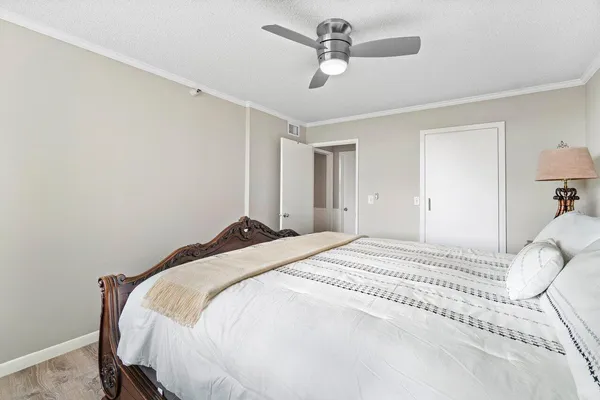a bedroom with a bed and a chandelier