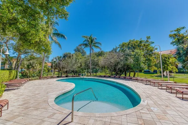 a swimming pool with outdoor seating and yard