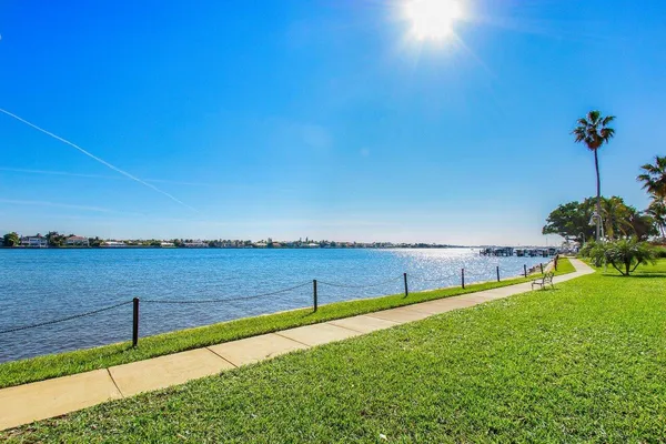 a view of a green field with an ocean view