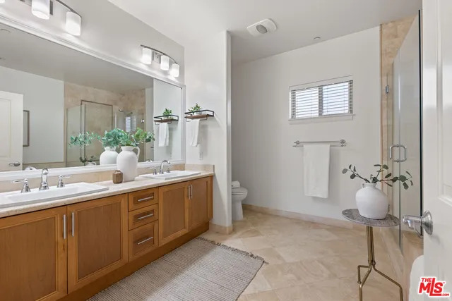a spacious bathroom with a double vanity sink and a mirror