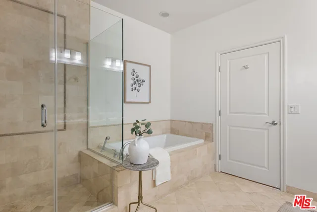 a bathroom with a bathtub and shower