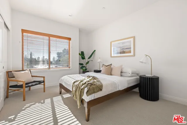a bedroom with a bed and a view of balcony