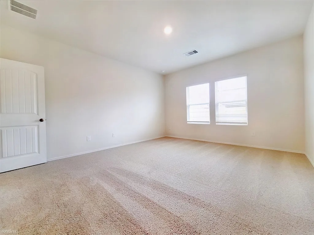 419 Sickle Loop Kyle, TX 78640 - Photo 25 of 35 A quiet retreat with plush carpeting and abundant natural light from multiple windows.