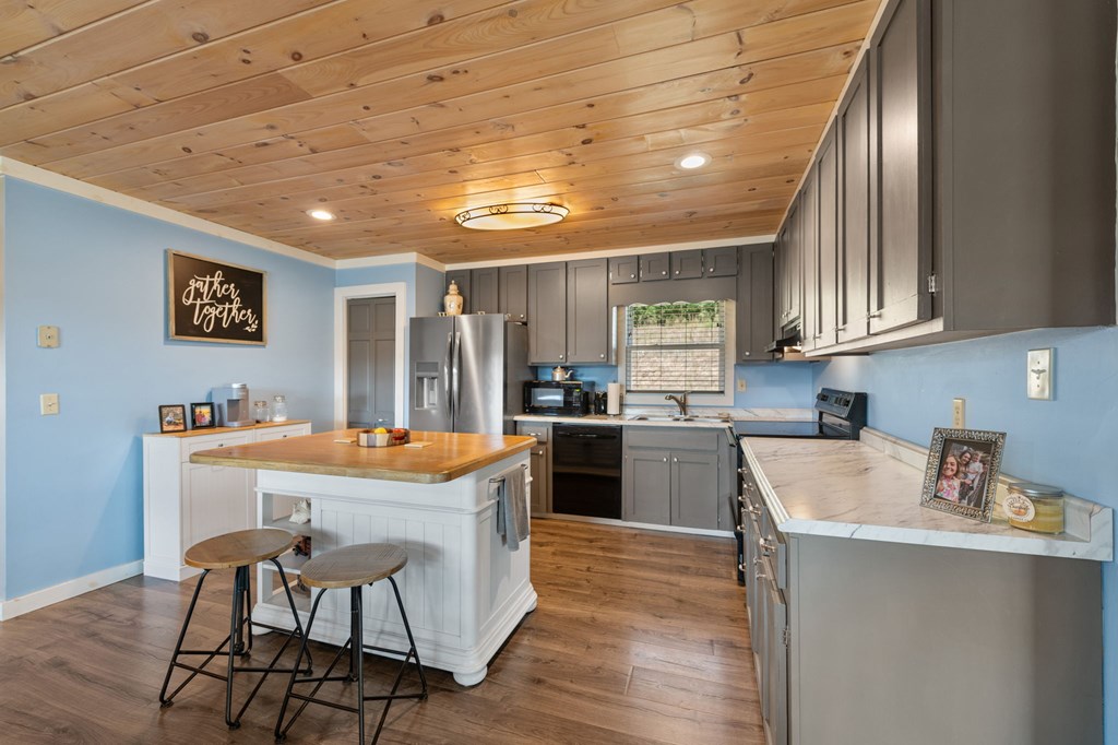 1201 Ada Street Blue Ridge, GA 30513 - Photo 19 of 62 a kitchen with a sink a counter top space and stainless steel appliances