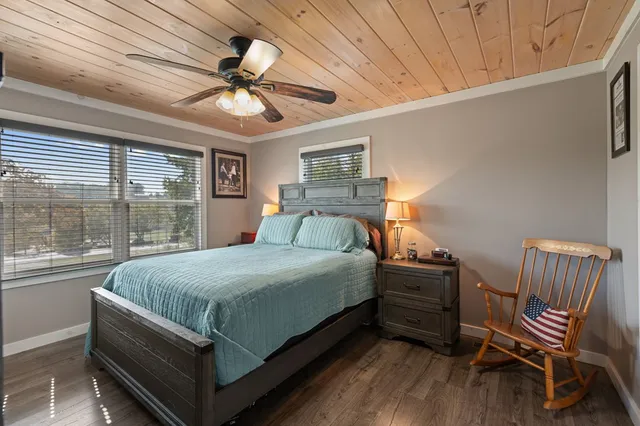 a bedroom with a bed and a flat tv screen