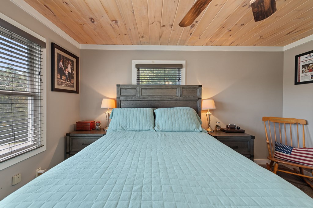 1201 Ada Street Blue Ridge, GA 30513 - Photo 28 of 62 a bedroom with a bed and wooden floor