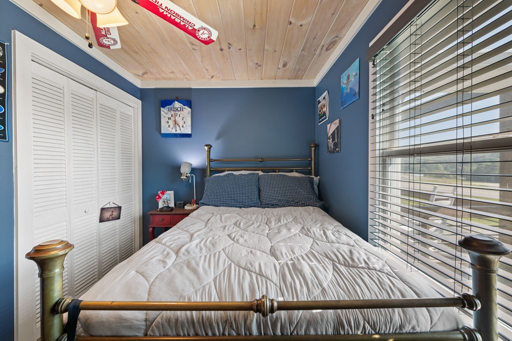 1201 Ada Street Blue Ridge, GA 30513 - Photo 34 of 62 a bed sitting in a bedroom next to a window