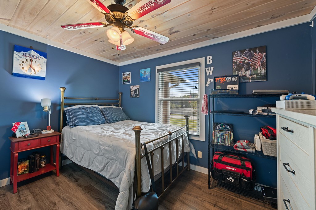 1201 Ada Street Blue Ridge, GA 30513 - Photo 35 of 62 a bedroom with a bed and a chandelier