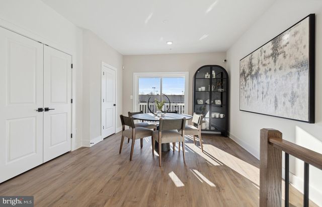 a dining room with furniture and wooden floor