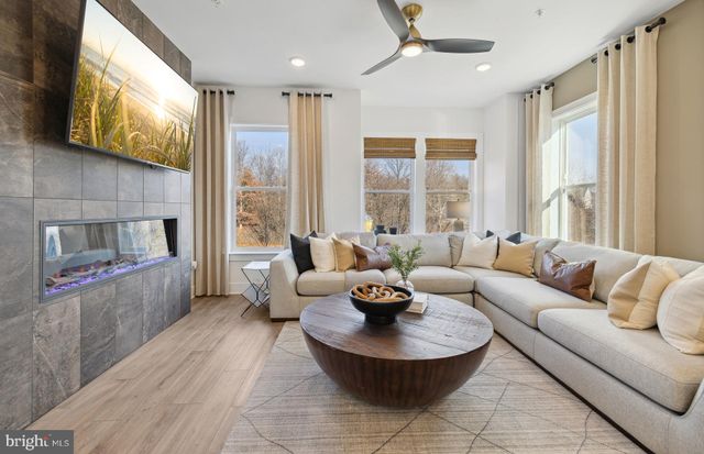a living room with fireplace furniture and a large window