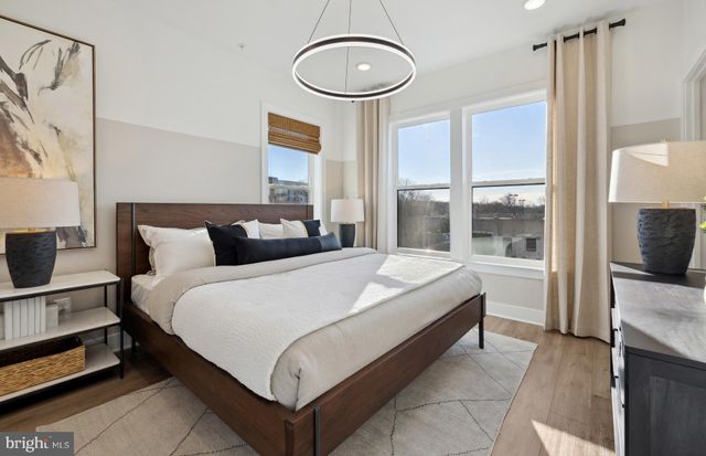 a bedroom with a bed and a large window