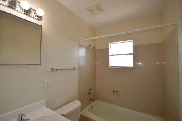 a bathroom with a bathtub and shower