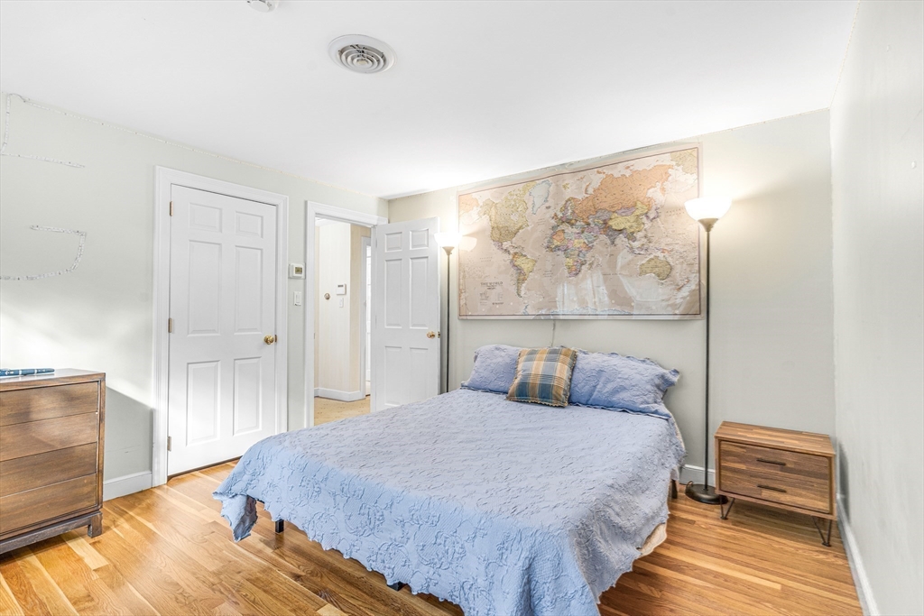 46 Round Hill Road Lincoln, MA 01773 - Photo 23 of 42 a bedroom with a bed and a painting on the wall