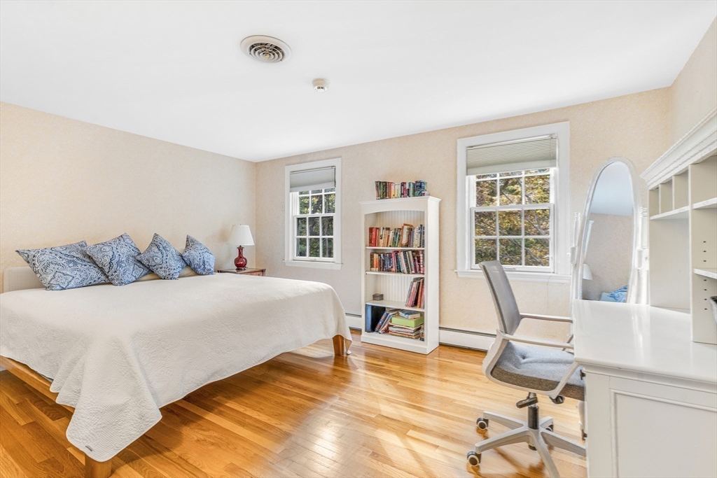 46 Round Hill Road Lincoln, MA 01773 - Photo 24 of 42 a bedroom with a bed a table and chair