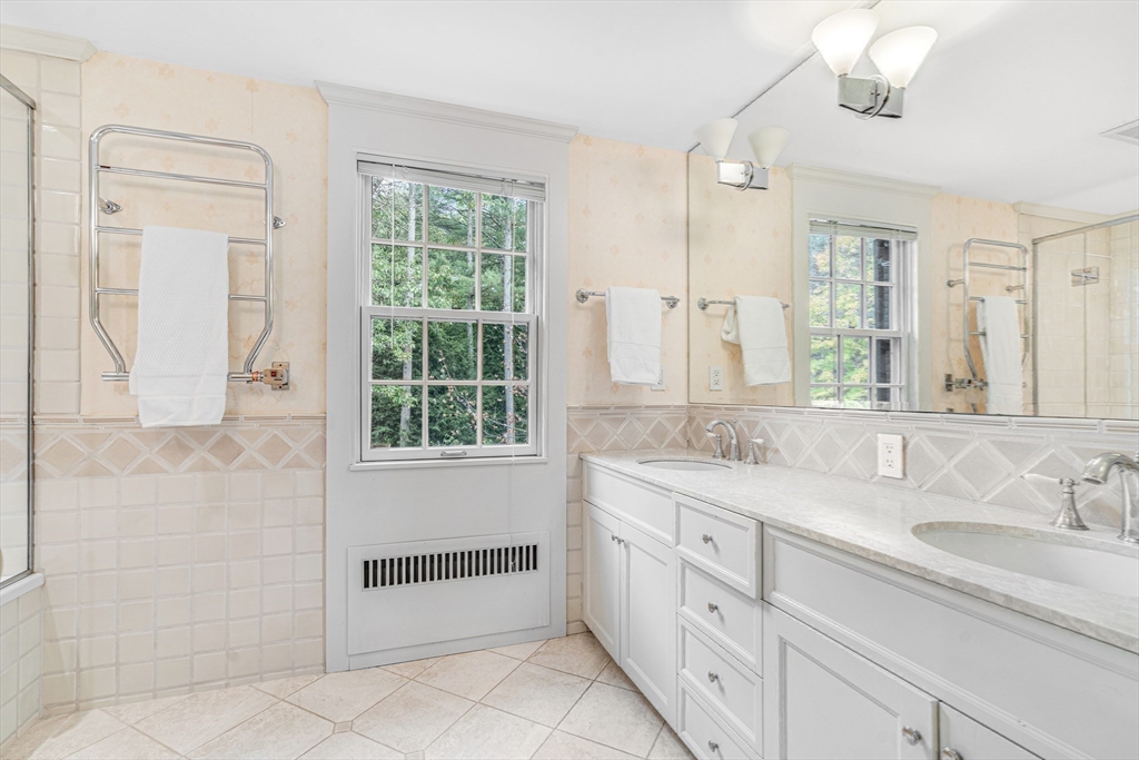 46 Round Hill Road Lincoln, MA 01773 - Photo 26 of 42 a bathroom with a granite countertop sink mirror and a bathtub