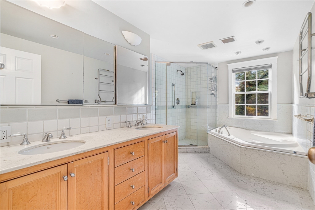 46 Round Hill Road Lincoln, MA 01773 - Photo 28 of 42 a bathroom with a double vanity sink a toilet a mirror and bathtub