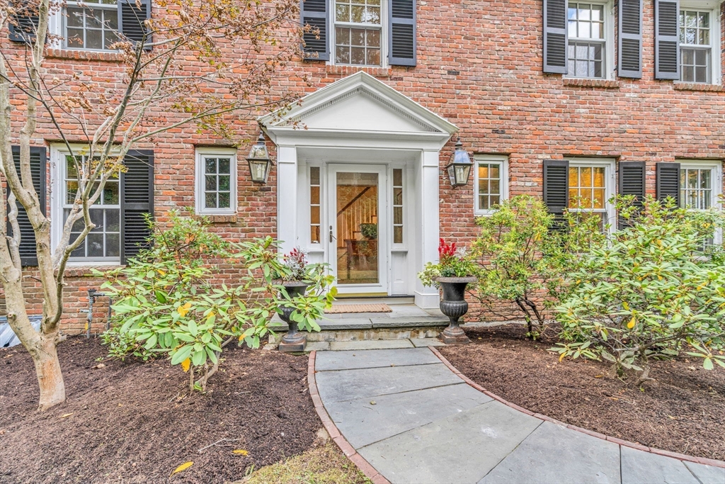 46 Round Hill Road Lincoln, MA 01773 - Photo 3 of 42 front view of a brick house with potted plants