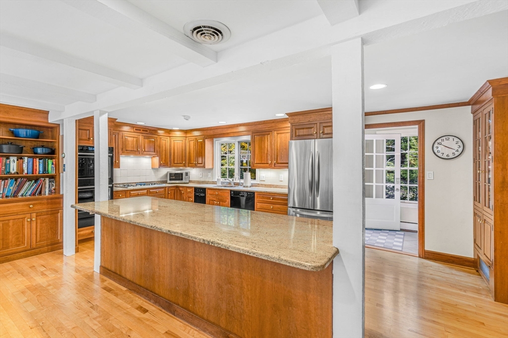 46 Round Hill Road Lincoln, MA 01773 - Photo 6 of 42 a large kitchen with stainless steel appliances granite countertop a large window and a counter space