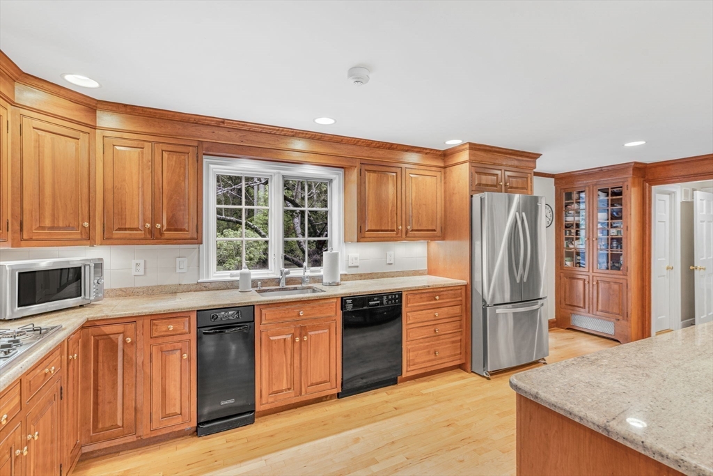 46 Round Hill Road Lincoln, MA 01773 - Photo 9 of 42 a kitchen with stainless steel appliances granite countertop a refrigerator and a sink