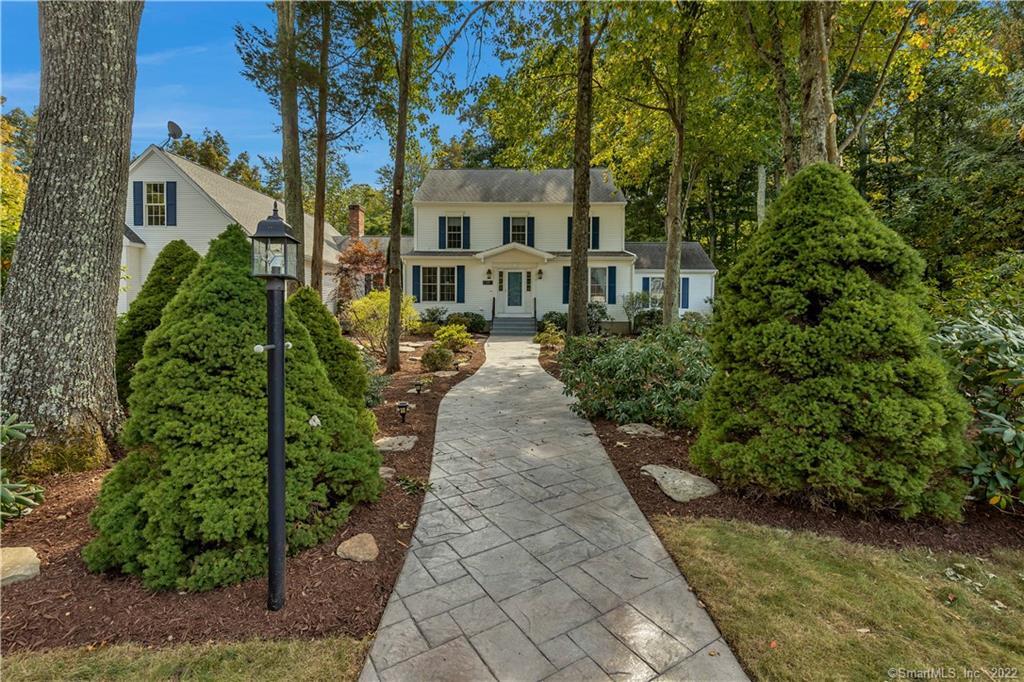 Front view of walkway from road and professionally landscaped yard.