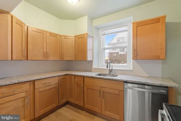 a kitchen with a sink cabinets and window