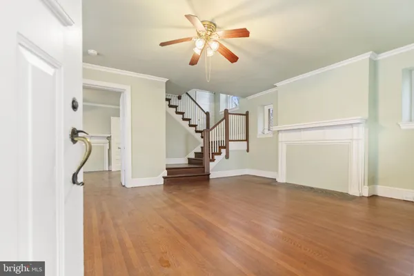 a view of empty room with wooden floor