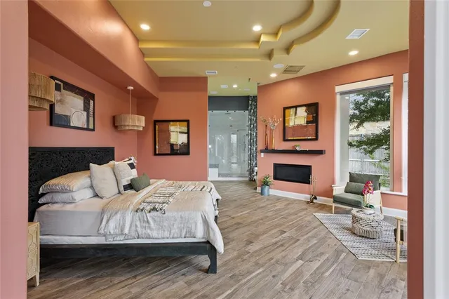 a bedroom with a large bed and a large window