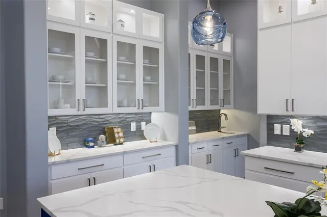 a kitchen with a sink and cabinets