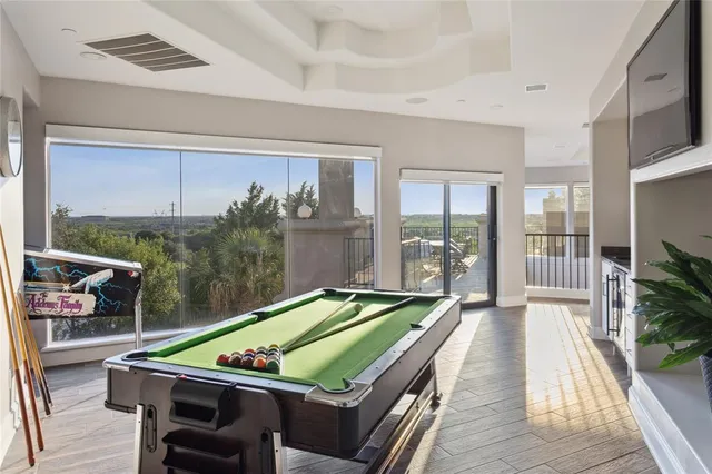 a room with furniture pool table and flat screen tv