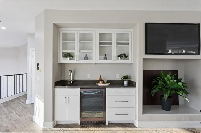 a kitchen with a sink and a potted plant