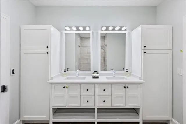 a bathroom with a double vanity sink and mirror