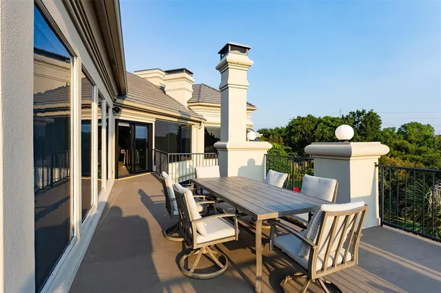 a view of a patio with table and chairs and potted plants