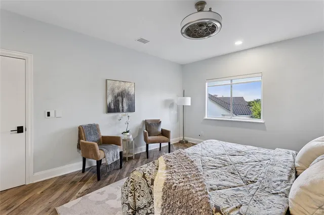a bedroom with furniture and a window
